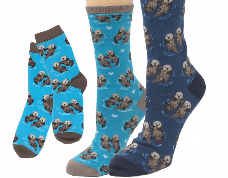 three pairs of socks in shades of blue with sea otter design