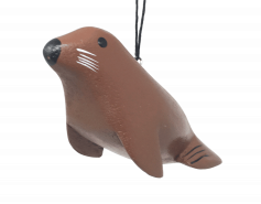 painted wooden ornament shaped like a sea lion
