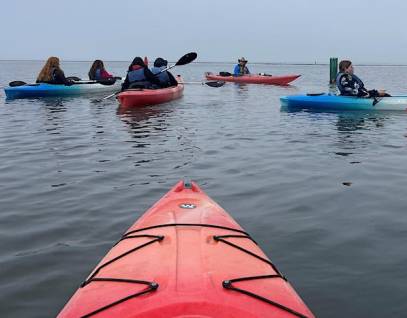 young people kayaking from POV of a kayaker