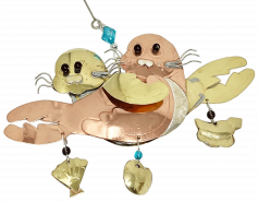 gold and copper colored metal ornament with two seal pups