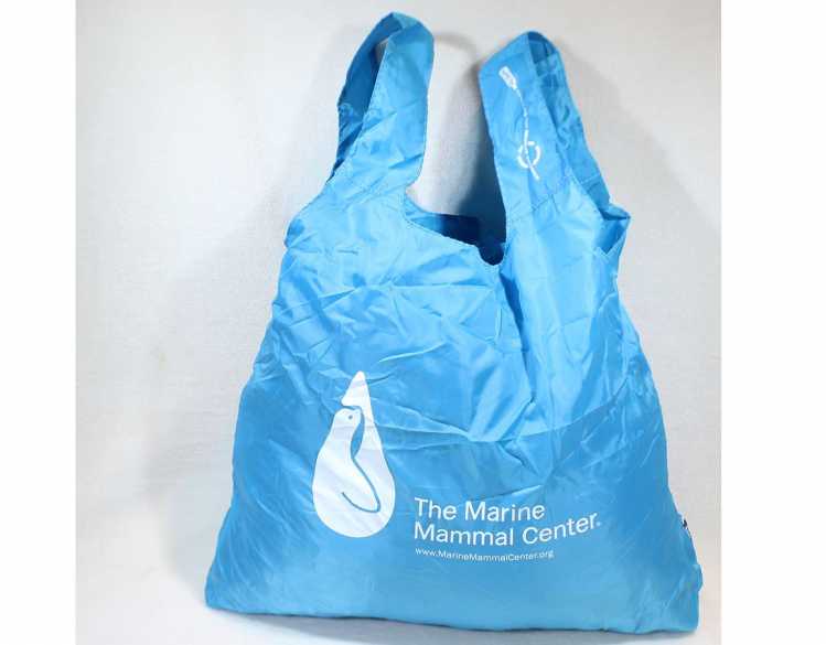 blue tote with The Marine Mammal Center logo in white