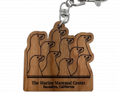 wooden keychain with 10 sea lions and the words The Marine Mammal Center