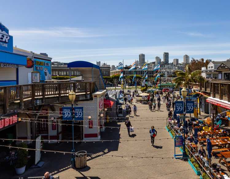 PIER 39 shops and restaurants with San Francisco skyline in the distance