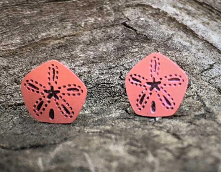 terra cotta-colored earrings in sand-dollar shape